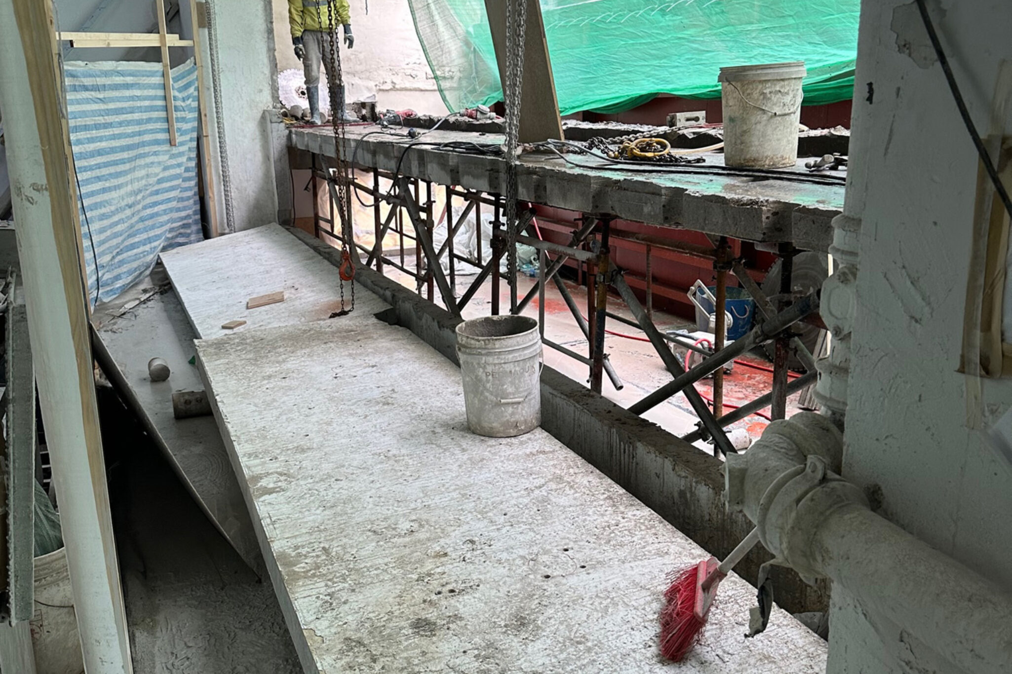 A wide-angle shot of a construction site with raw materials and tools nearby, a design and development project by Studio X