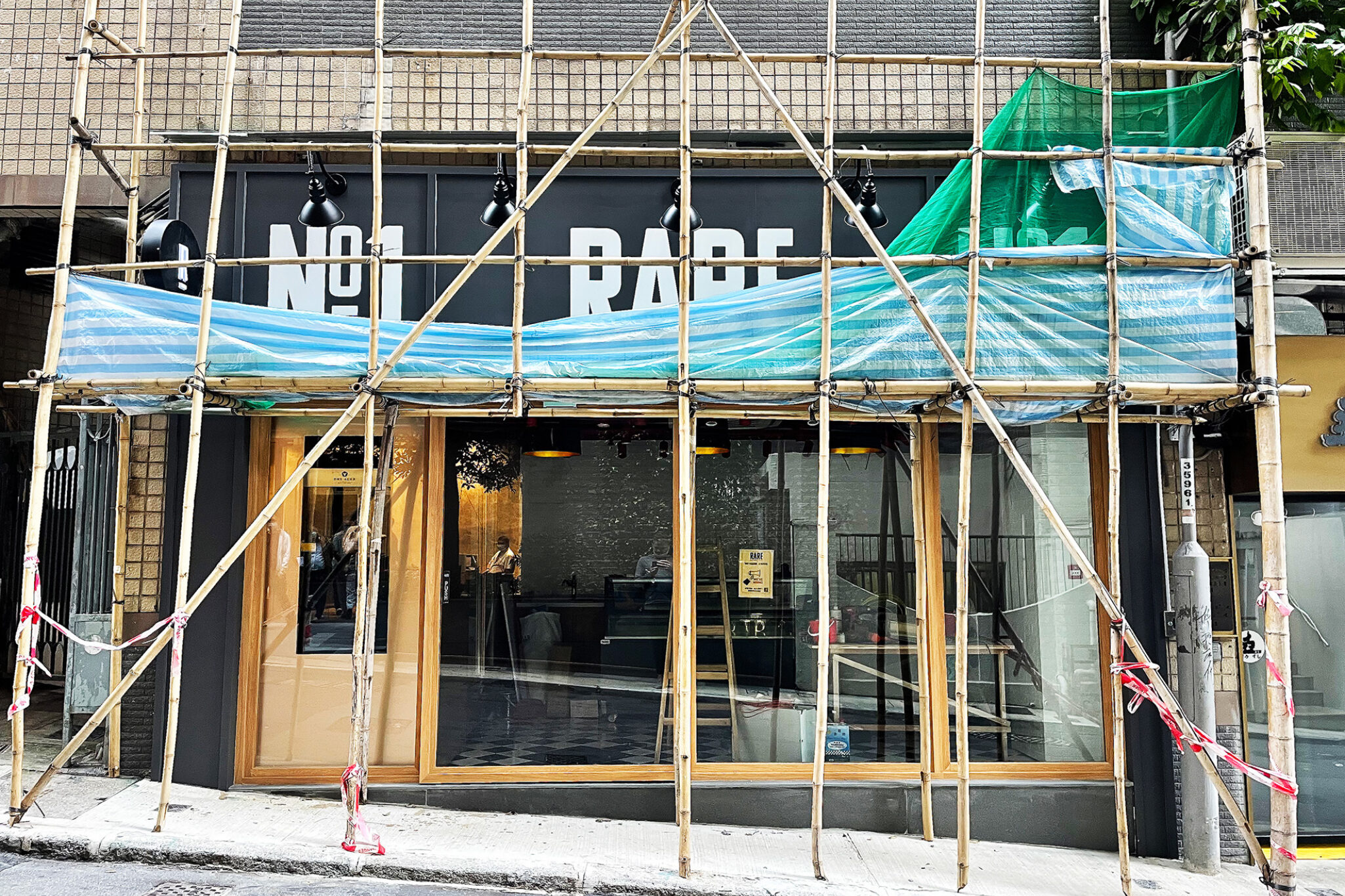 Front view of the 'RARE' food outlet with construction in progress on its first floor, a retail project by Studio X