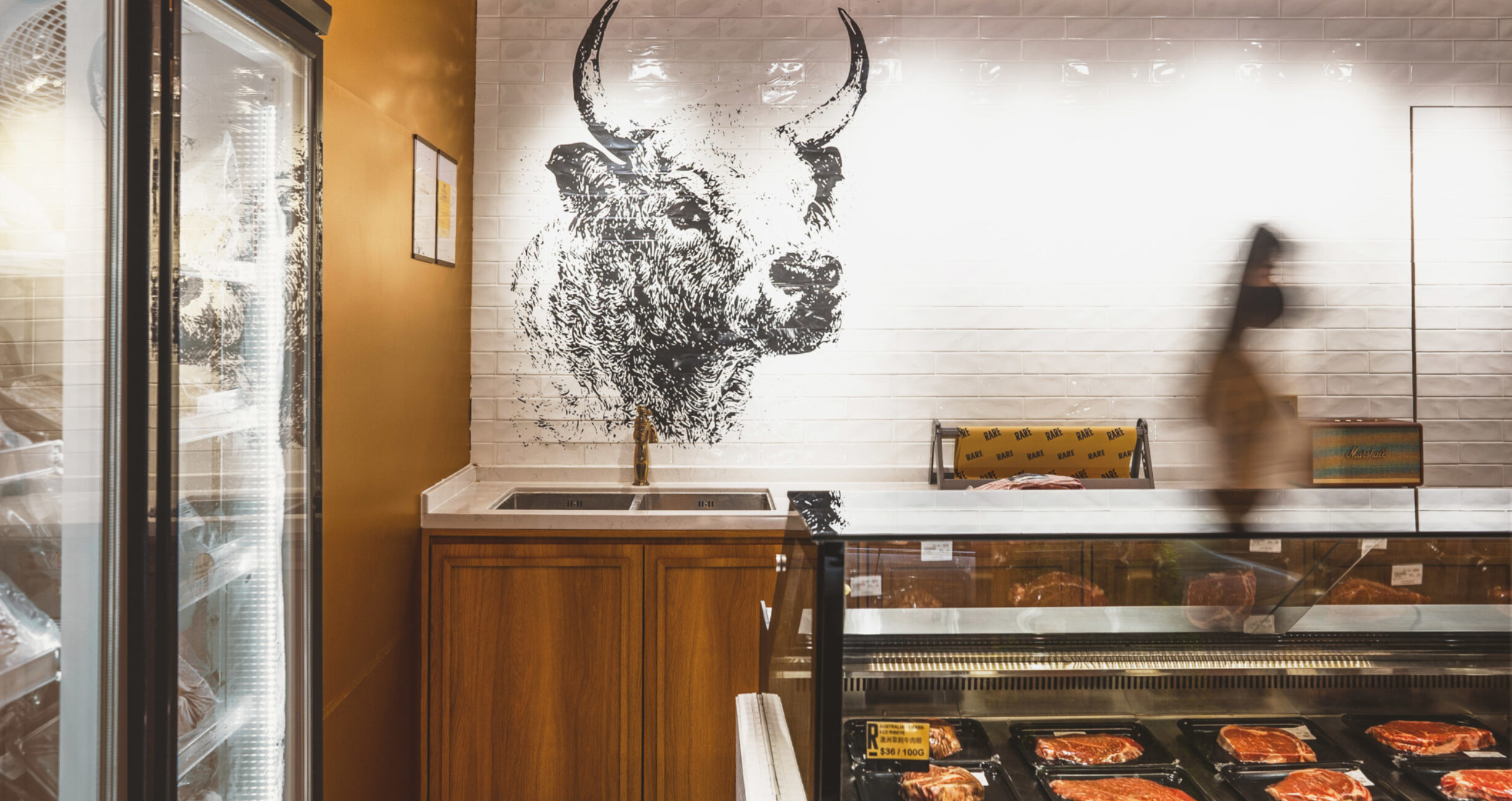 Inside a food store, a shot of the counter with several baked items neatly arranged, a project by Studio X