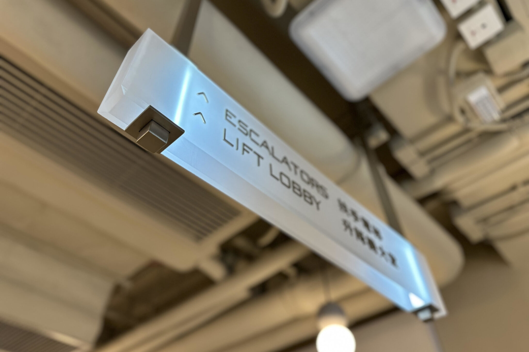Directional sign inside Yau Shing Commercial Centre by Studio X, indicating Lift Lobby and Escalators